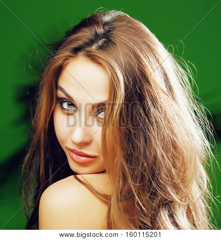 young cute blonde woman on green palm background smiling happy, lifestyle peole concept close up