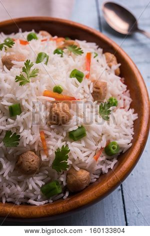 Yummy soya pulao or pilav or pulav or rice or soyabean chunk fried rice with peas and beans, indian or pakistani cuisine