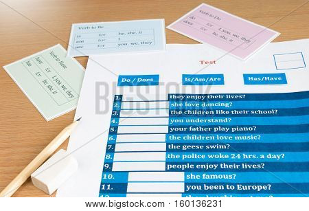 blue english verb test with cards on table