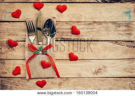 Table Set For Celebration Valentine's Day. Wooden Table Place Setting And Silverware With Red Heart 