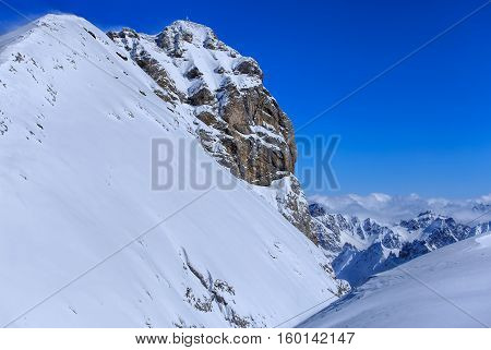 Summit of Mt. Titlis in the Swiss Alps on a windy day in winter. Mount Titlis is a mountain of the Uri Alps, located on the border between the Swiss cantons of Obwalden and Bern.