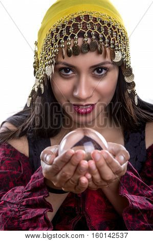 Close up of female fortune teller or psychic with clear crystal ball for composites. Facial expressions indicate she is seeing a vision on in the orb.