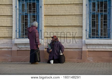KAZAN, RUSSIA, 19 NOVEMBER 2016, A homeless female beggar is begging on the baumana street near orthodox church, horizontal