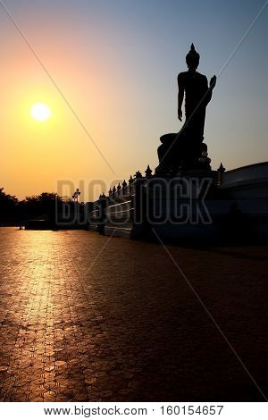 beautiful landscape silhouette buddha statue sacred with sunset on blue sky at phutthamonthon in Thailand