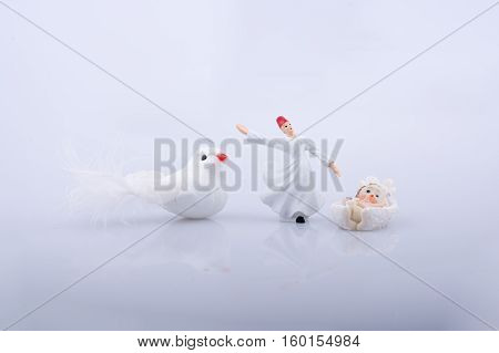 Whirling dervish by the side of a white bird on white background