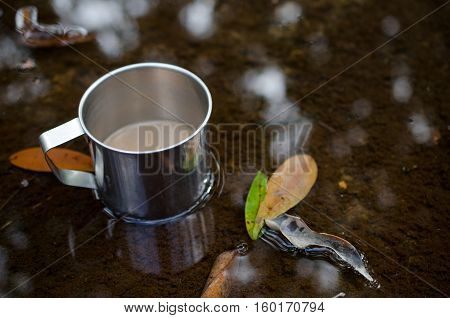 Place in a glass of hot coffee and cold clear streams. White sandals relaxing waterfront.