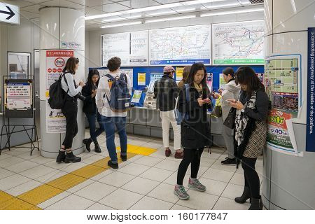 Tokyo, Japan - NOV 18, 2016 :Passengers buying train ticket with ticket machine in the Tsukiji Station