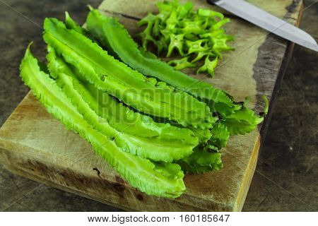 Winged beans on wooden background, Princess bean, Goa bean