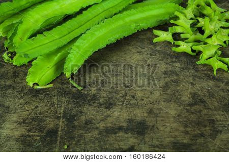 Winged beans on wooden background, Princess bean, Goa bean