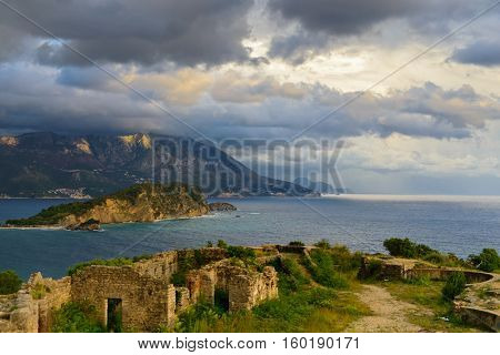 View to Budva bay from ruins of medieval fortress Tvrdava Mogren at the shore of Adriatic sea. Historic attractions of Budva, Montenegro
