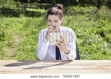 Business Woman Eating An Apple And Reading Messages