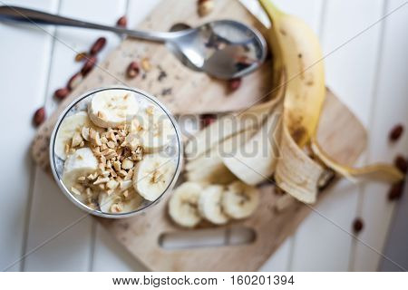 Banana chia yogurt pudding decorated with ripe sliced banana and peanuts