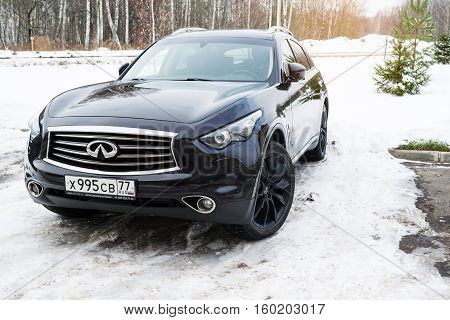 Smolensk, Russia - November 13, 2016: Luxury crossover Infiniti QX parked in winter forest.