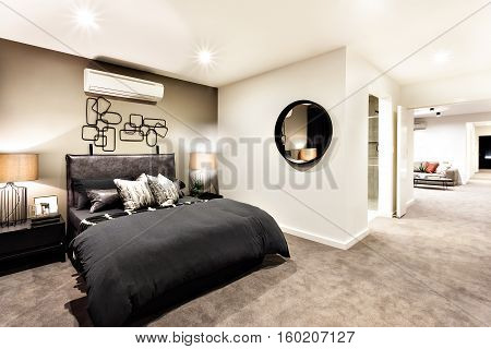 Modern bedroom with a hallway to other rooms and illuminated with night lights