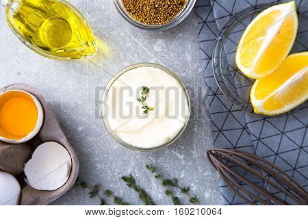 Fresh Homemade White Sauce Mayonnaise And Ingredients Eggs, Lemon Olive Oil On Stone Background. Top