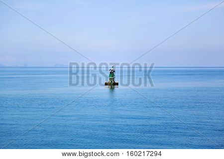 View on the ocean with beacon - seamark in the middle of the frame.