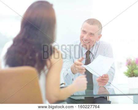 boss discusses with the assistant business documents in the offi