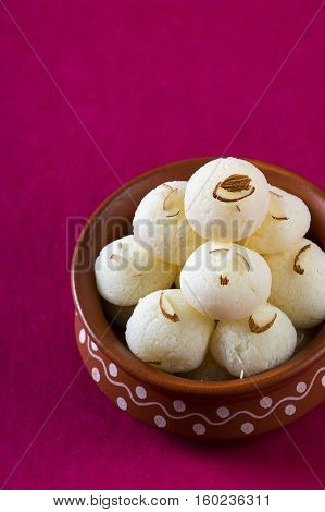 Indian Sweet or Dessert - Rasgulla, Famous Bengali sweet in clay bowl