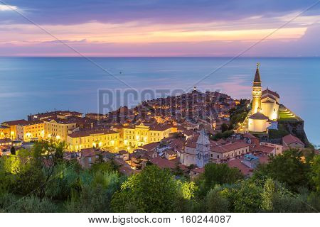 Romantic colorful sunset over picturesque old costal town Piran, Slovenia. Senic panoramic view.