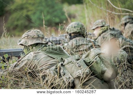 Camouflaged Army Soldiers With Guns