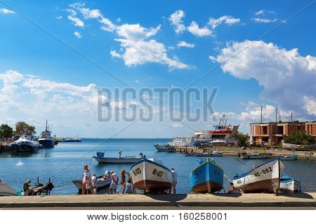NESEBAR BULGARIA SEPTEMBER 06 2013: Fishing boats at the pier in the harbor of the old town of Nessebar Bulgaria. Clear sunny summer day on the Bulgarian Black Sea Coast.