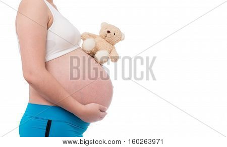 The belly asia pregnant woman holdind a teddy bear doll isolate on white background
