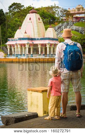 Father and child at Ganga Talao temple. Mauritius. 