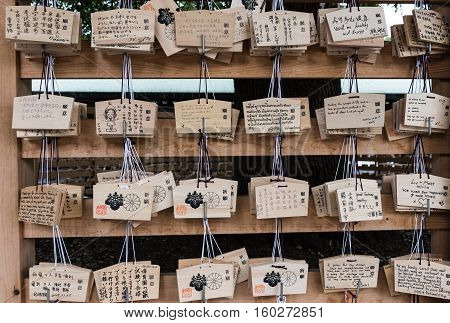 Meiji Jingu Shrine, Shibuya, Tokyo, Japan - December 6, 2015: Japanese votive plaque (Ema) hanging in Meiji Jingu Shrine. Ema are small wooden plaques used for wishes by shinto believers.