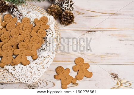 Christmas smiling gingerbread men men and women on white handmade lace with Christmas decoration