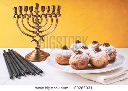 Hanukkah still life with menorah and sufganiot