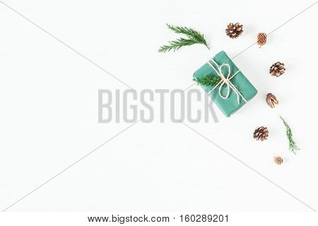 Christmas composition with pine cones cypress branches christmas gift. Top view flat lay