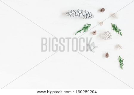 Christmas composition. Frame made of christmas decoration cypress branches pine cones. Flat lay top view