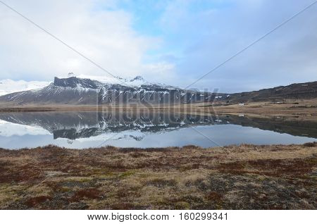 Gorgeous snow covered mountain reflecting in the water.