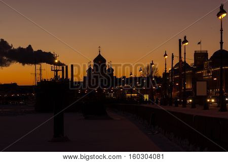 the port and the Church of the Assumption View from Lieutenant Schmidt Embankment in St. Petersburg, Russia