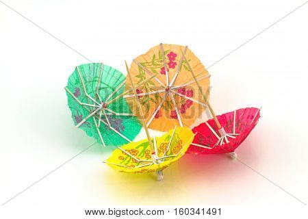 Close up colorful of many cocktail umbrellas on white background