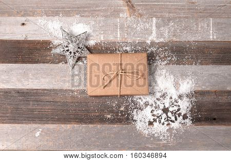Christmas decoration gift box and snowflake on wooden background