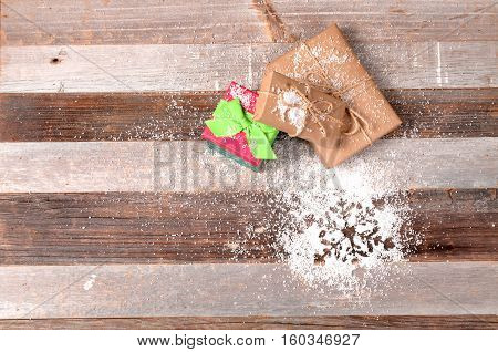 Christmas gifts. Snowflake on the wooden background
