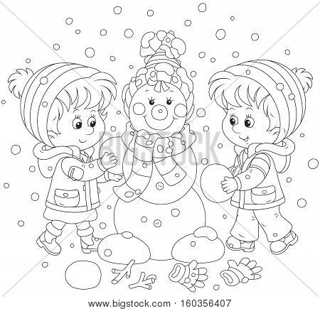 Small children making a funny Christmas snowman