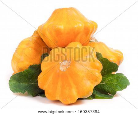 four yellow pattypan squash with leaf isolated on white background.