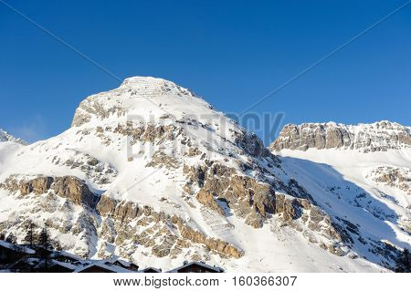Alpine winter mountain landscape. French Alps covered with snow in sunny day. Val-d'Isere, France