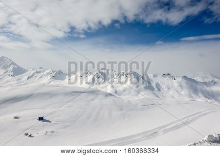 Alpine winter mountain landscape. French Alps covered with snow in sunny day. Val-d'Isere, France
