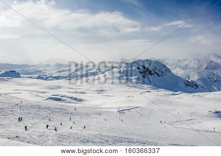 Alpine winter mountain landscape. French Alps covered with snow in sunny day. Val-d'Isere, France