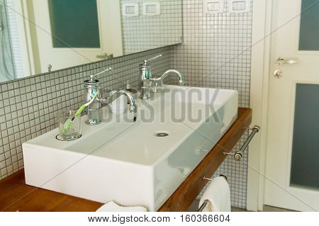 Beautiful modern white washbasin for two persons .