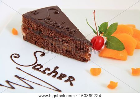 fresh chocolate sacher cake with decoration on plate