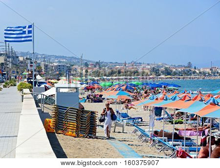 PERIVOLIA, CRETE - SEPTEMBER 15, 2016 - Tourists relaxing on the sandy beach Perivolia Crete Greece Europe, September 15, 2016.