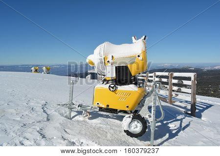 Three snow guns on the top of the mountain ready to extend ski season