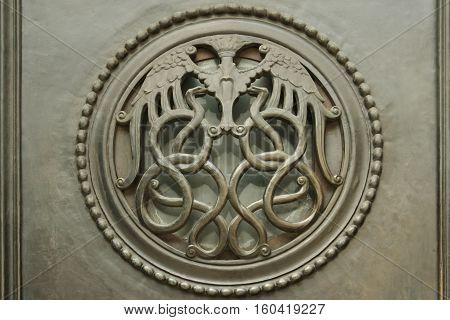 London UK - July 28 2007: interlocking serpents forming decorative grill on door Bank of England Threadneedle St London The Bank of England is the central bank of the UK