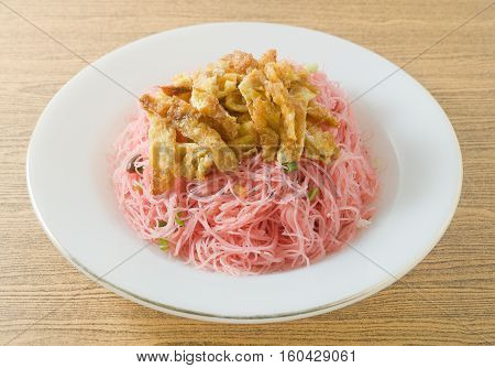 Thai Cuisine and Food Red Stir Fried Rice Vermicelli Served with Julienne Omelet and Chopped Scallion.