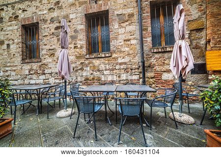 wrought-iron tables and chairs by a trattoria in Tuscany Italy
