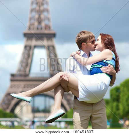 Man Carrying His Girlfriend In His Arms In Paris